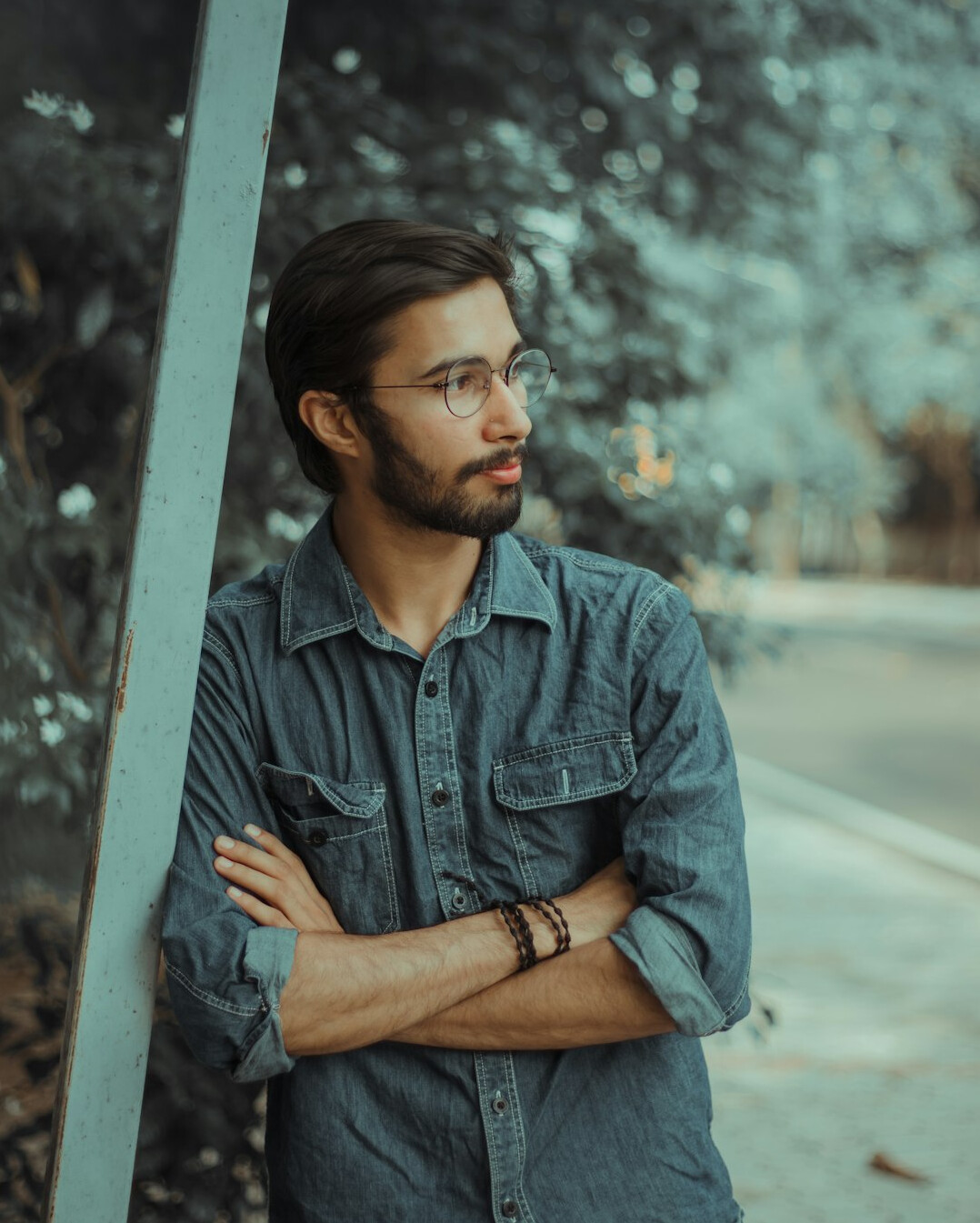 Portrait of a bearded man in casual shirt looking at camera